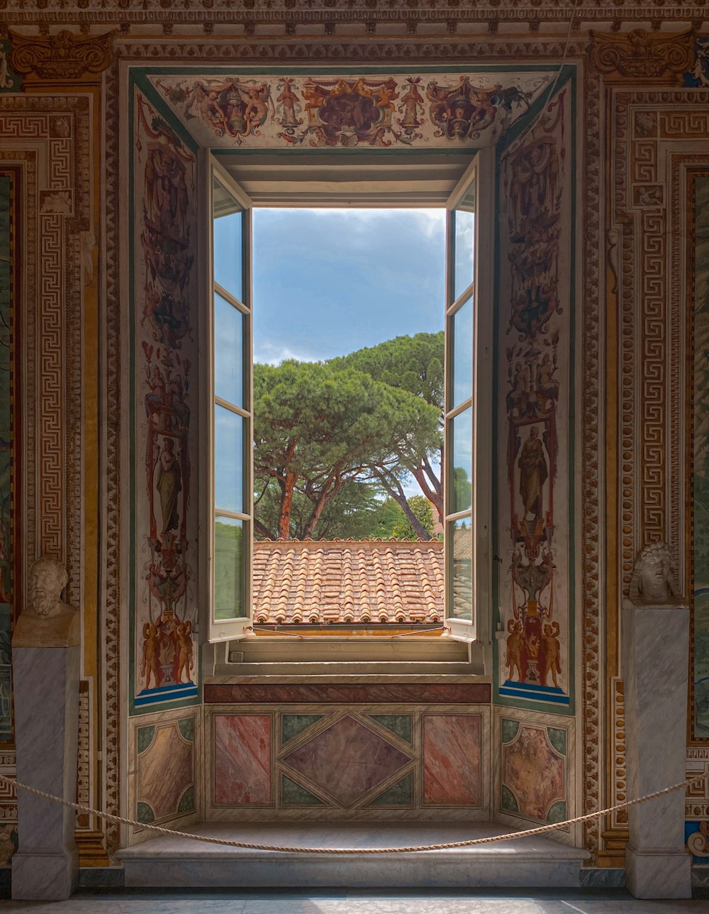 a window with a view of trees and a building