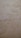 The surface displays various stains or patches that suggest water damage or mildew, with a textured pattern resembling an aged or neglected wall.