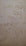 The surface displays various stains or patches that suggest water damage or mildew, with a textured pattern resembling an aged or neglected wall.