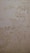The surface displays various stains or patches that suggest water damage or mildew, with a textured pattern resembling an aged or neglected wall.