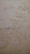 The surface displays various stains or patches that suggest water damage or mildew, with a textured pattern resembling an aged or neglected wall.