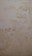 The surface displays various stains or patches that suggest water damage or mildew, with a textured pattern resembling an aged or neglected wall.