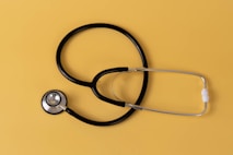 a black stethoscope on a yellow background