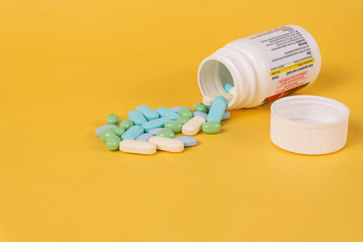 Capsules spilling from a white jar