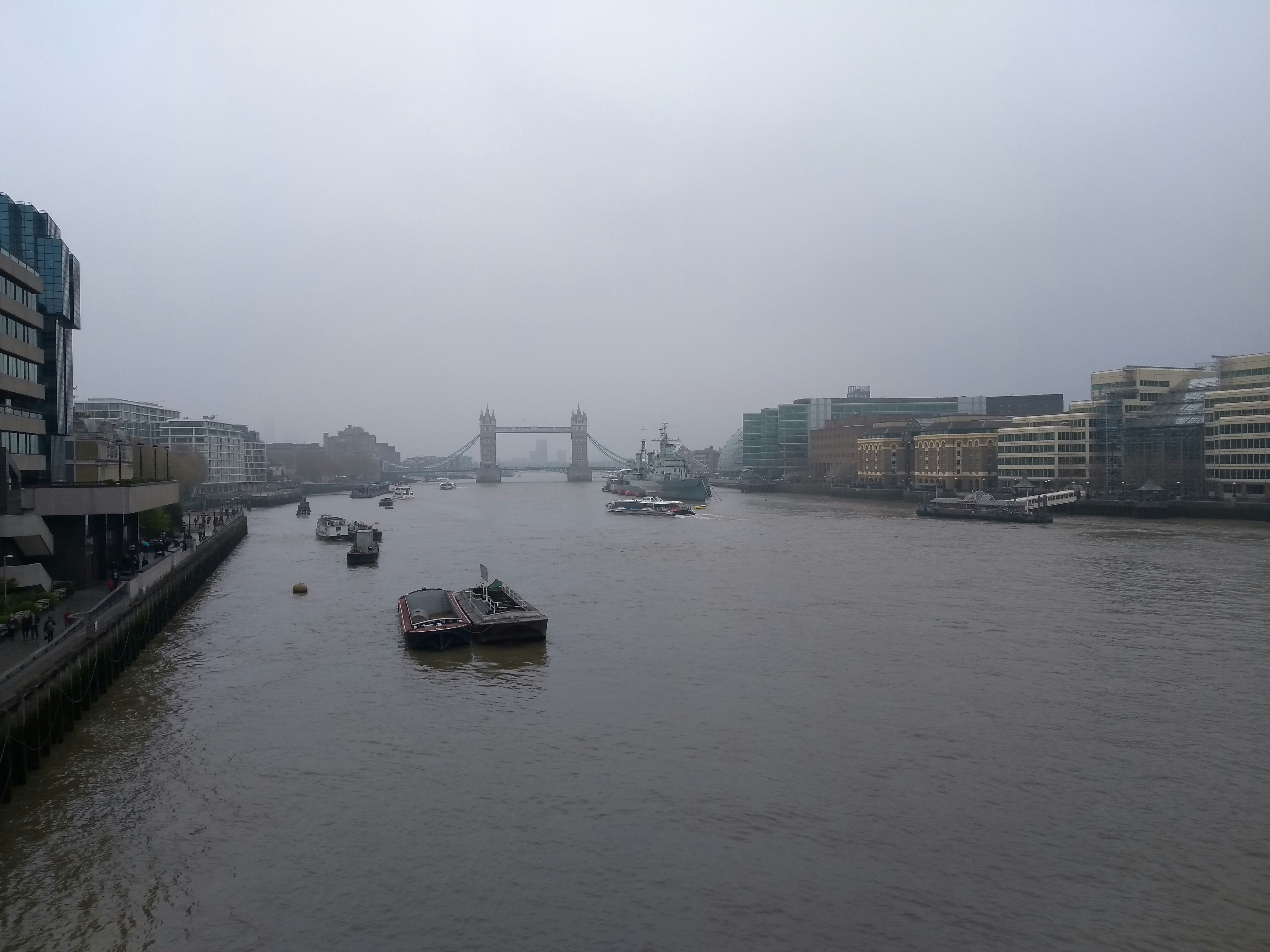 a river with boats in it and buildings in the back