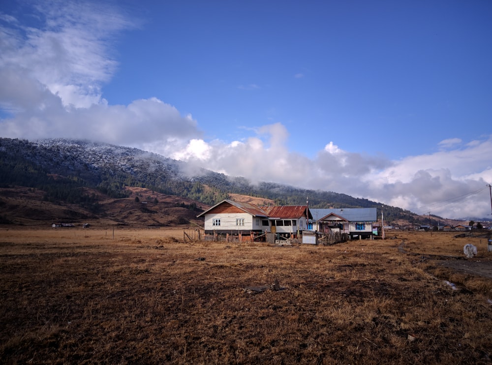 a couple of buildings in a field