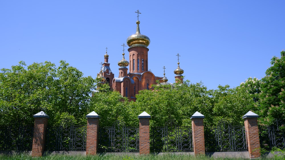 a building with a gold domed roof surrounded by trees
