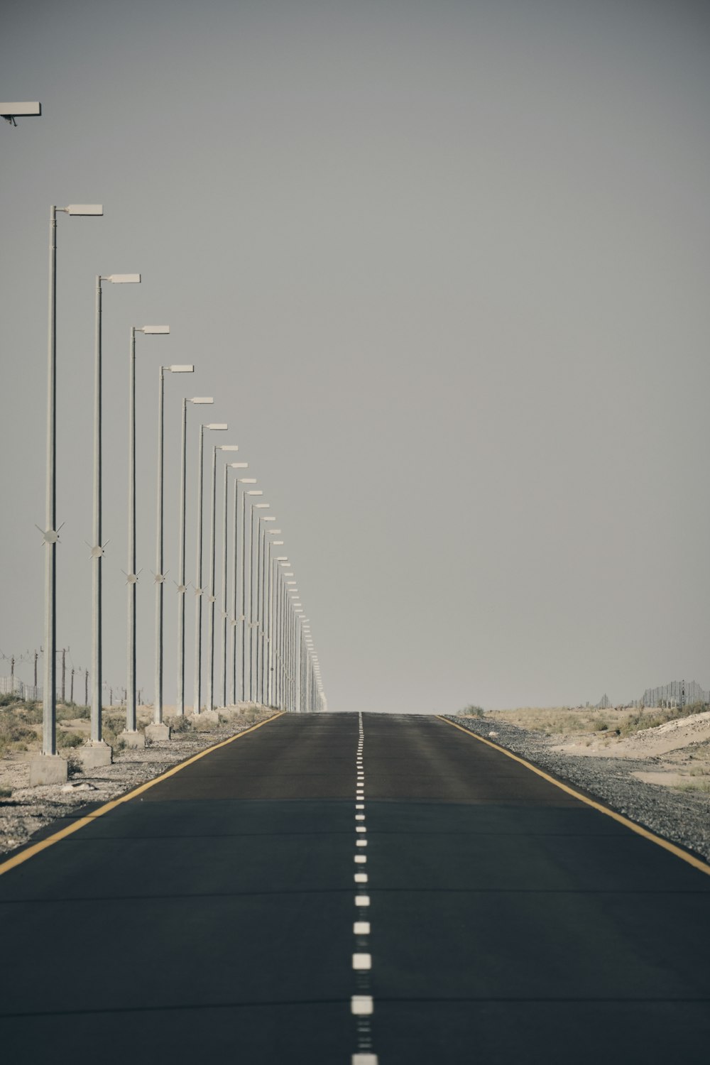a long straight road with lights on either side of it