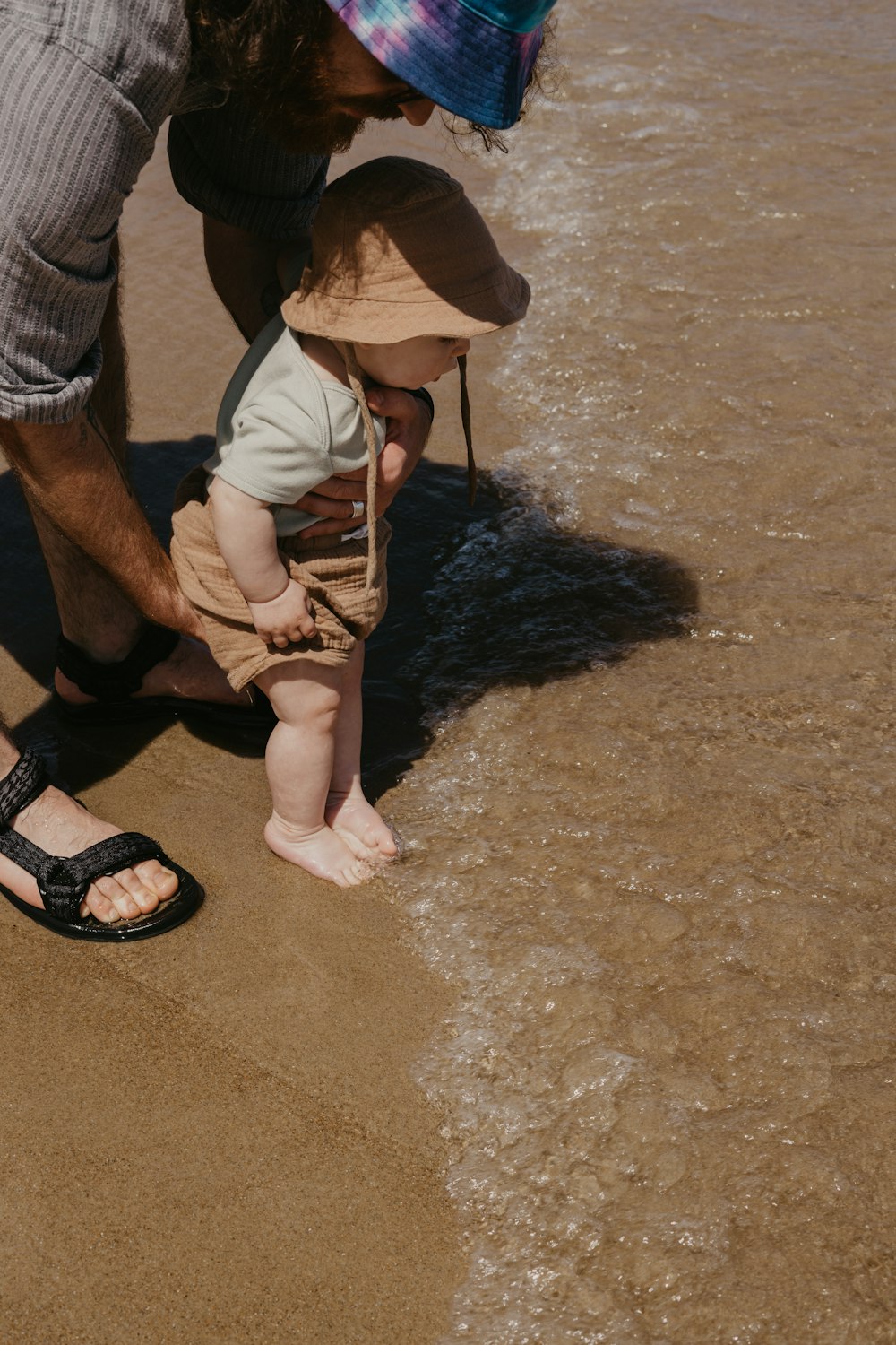 a person and a child playing in the mud