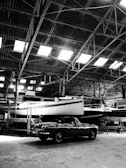 Marine spare parts section neatly arranged with propellers, steering systems, and batteries under soft ambient lighting.