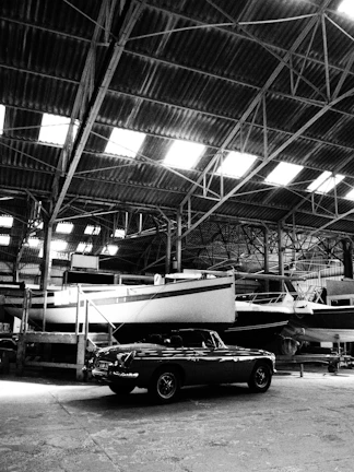 Marine spare parts section neatly arranged with propellers, steering systems, and batteries under soft ambient lighting.