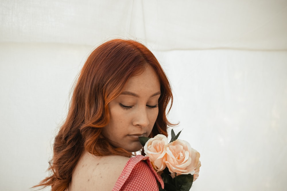 a woman smelling a flower