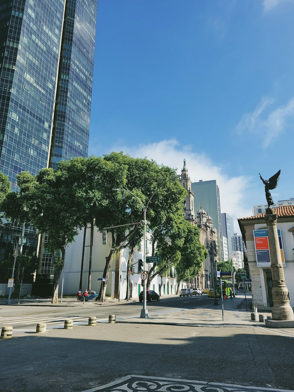 a street with trees and buildings on the side