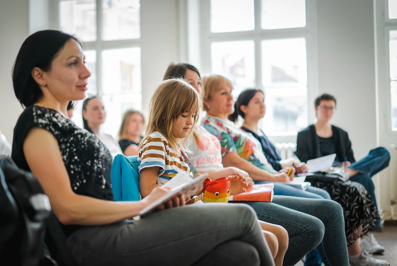 Parents seated together at a support group meeting