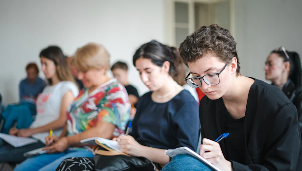 A focused adult learner participating in a hands-on finance seminar.
