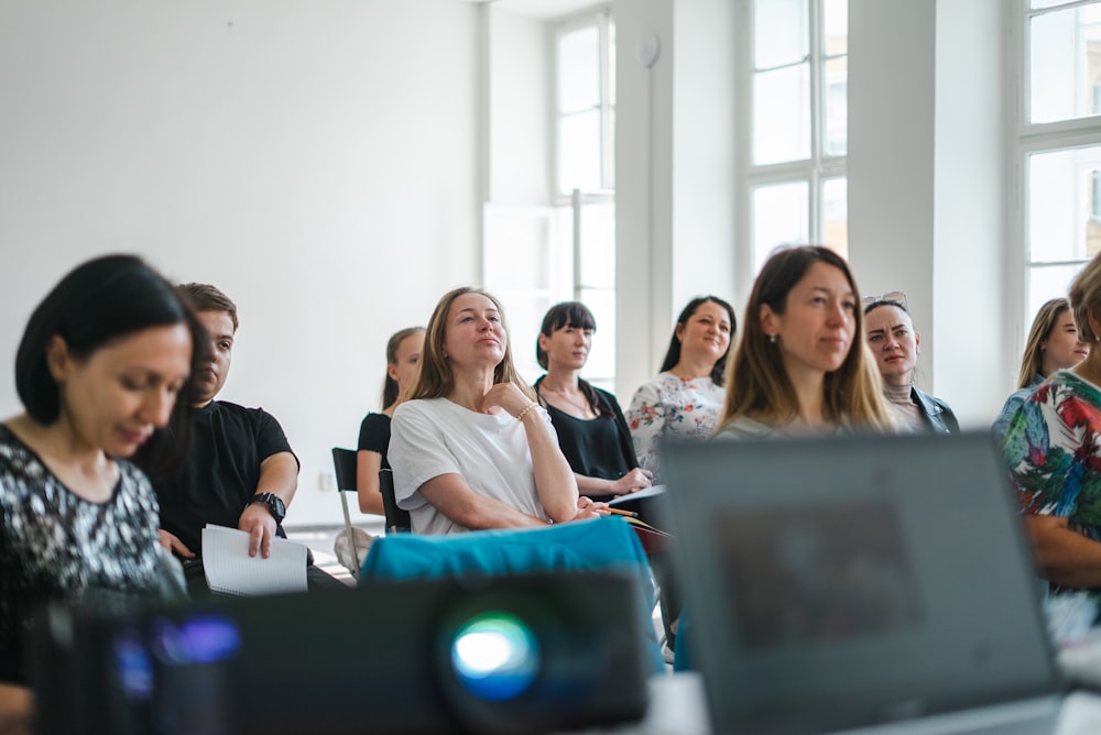 a group of people sitting at computers