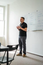 a person standing in front of a whiteboard