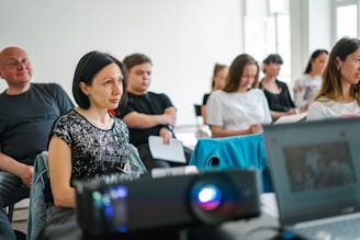 a group of people sitting at computers