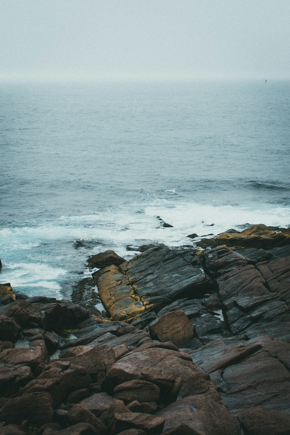 a rocky beach with waves crashing