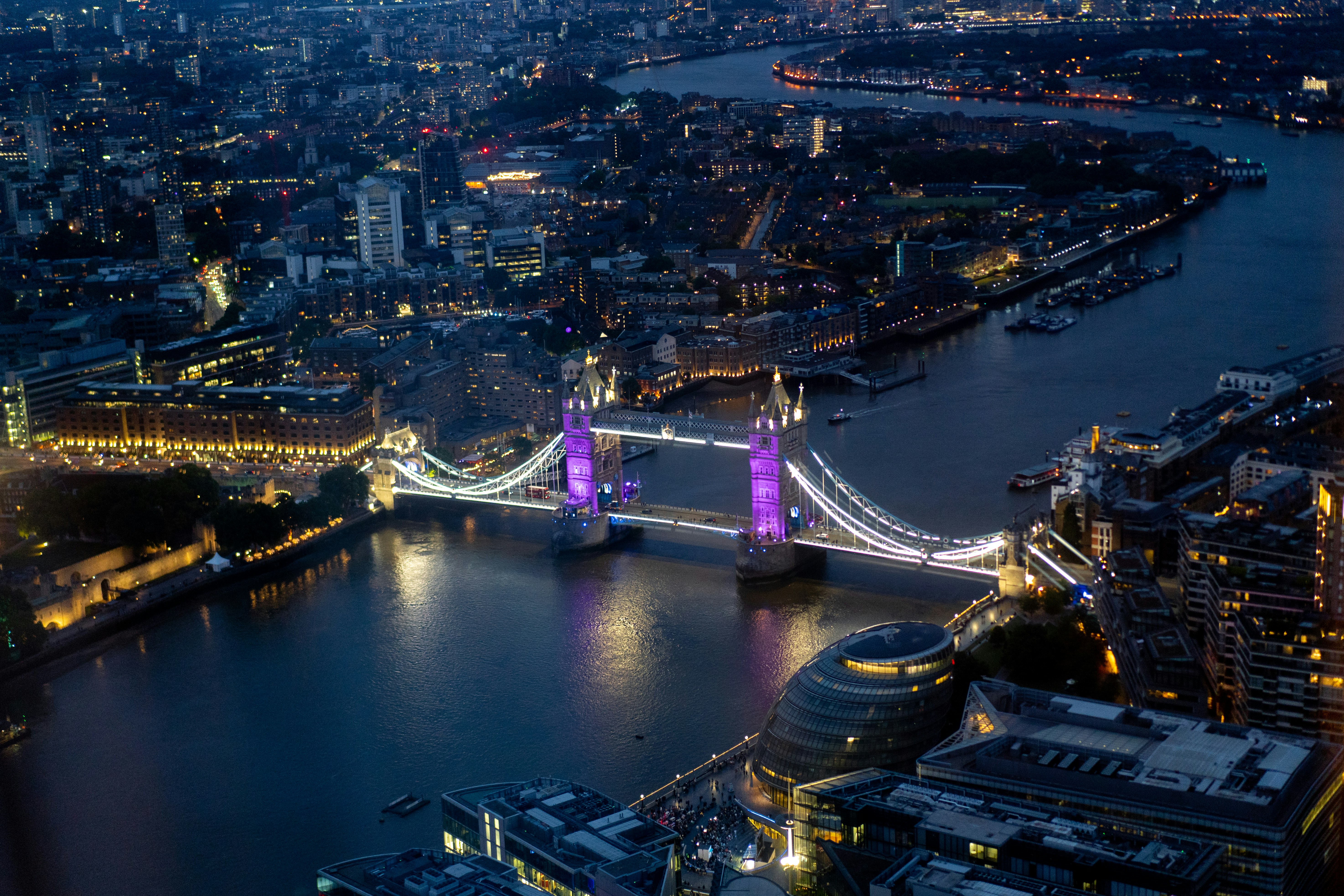 a bridge over a river with a city in the background