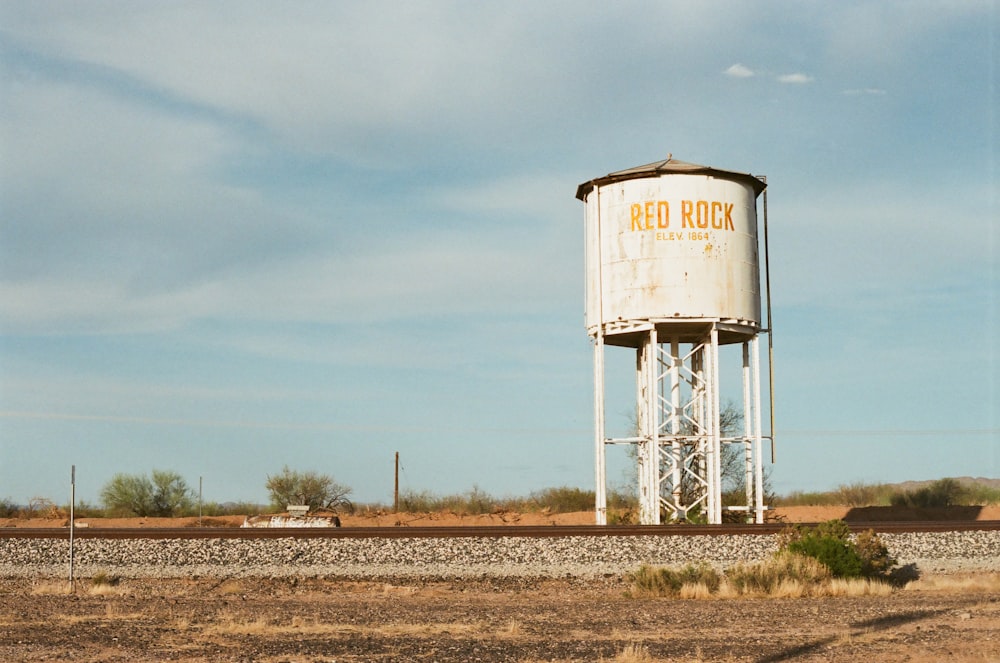 a water tower in a field
