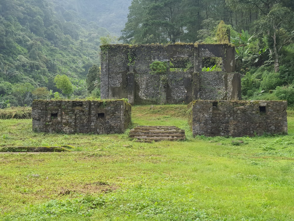 a stone building in a grassy field