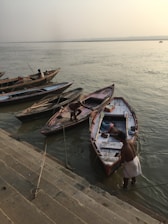 A serene cab parked near the ghats of Varanasi at sunrise, with pilgrims boarding.