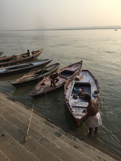 Calm waters of the Saryu Ghat reflecting the early morning light and boats.