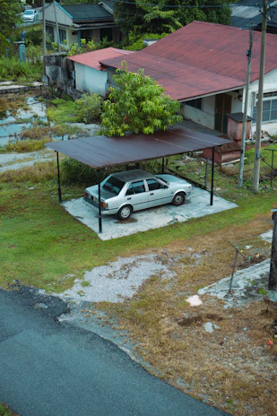 A sleek custom steel carport standing tall beside a rural home in Limpopo.