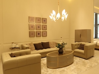 A luxurious living room featuring elegant beige furniture and golden accents.