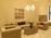 A beautifully arranged living room featuring elegant wooden furniture and soft beige accents.