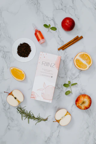 A vibrant flat lay of Herbalife products surrounded by fresh fruits and leaves, symbolizing health and vitality.