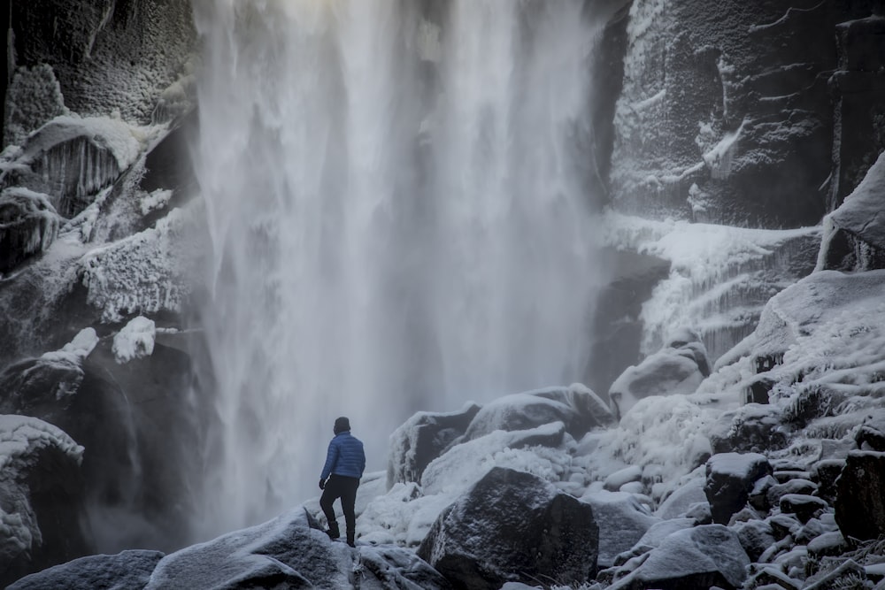 a person standing in front of a waterfall