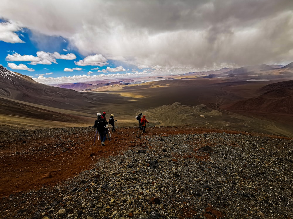 a group of people hiking in the mountains