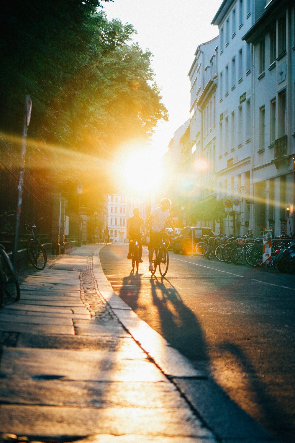 a group of people riding bikes on a sidewalk