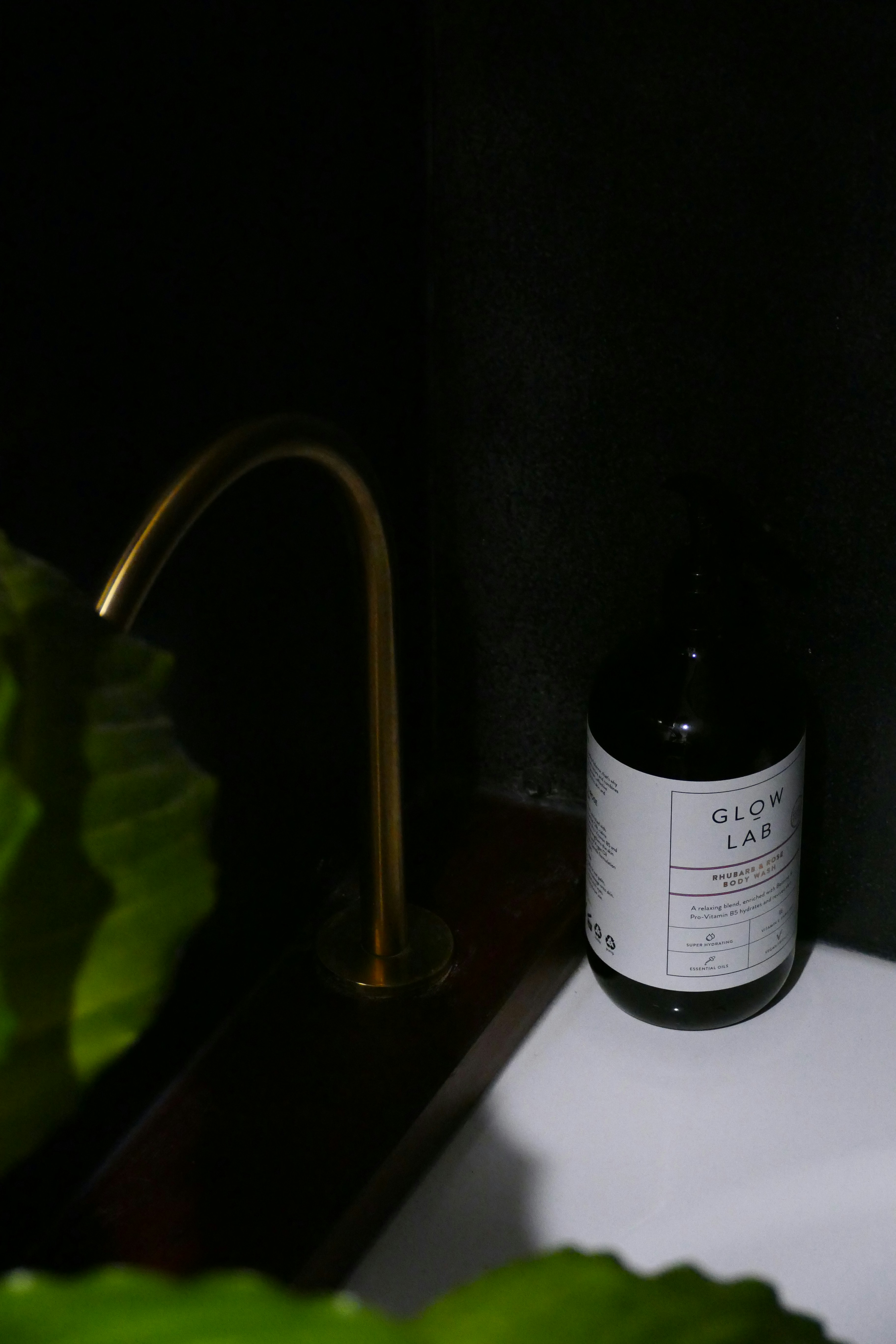 A bottle of hyaluronic acid serum next to skincare products