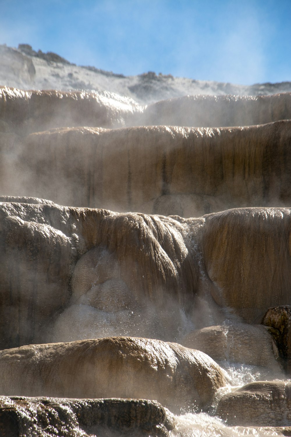 a large waterfall with mist