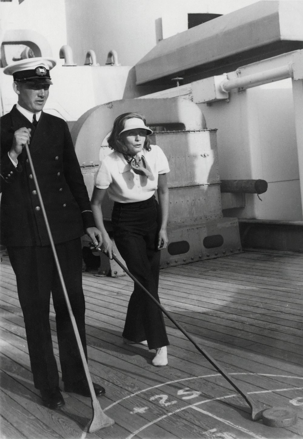 a man and woman walking on a boat