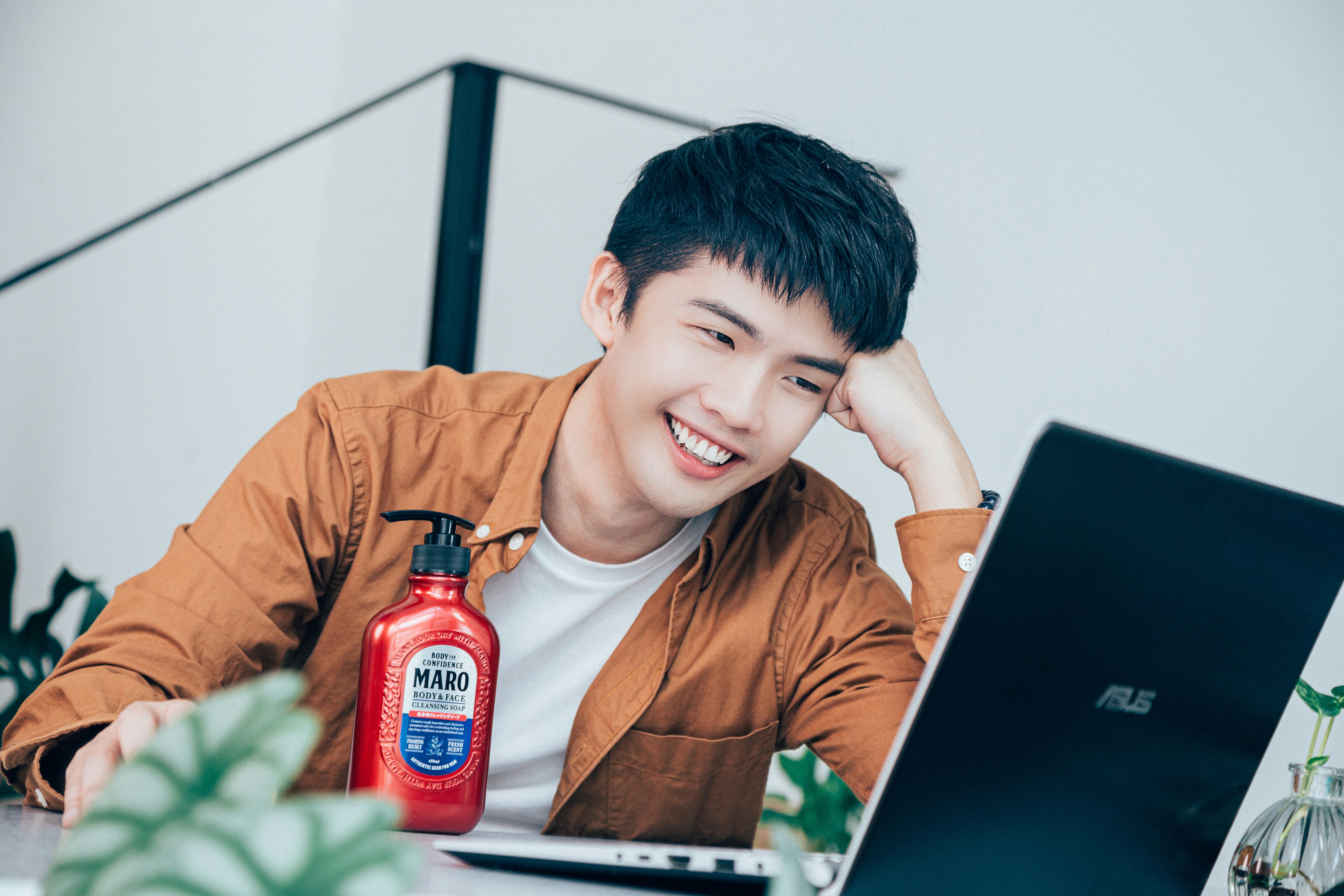 a person smiling and looking at a laptop