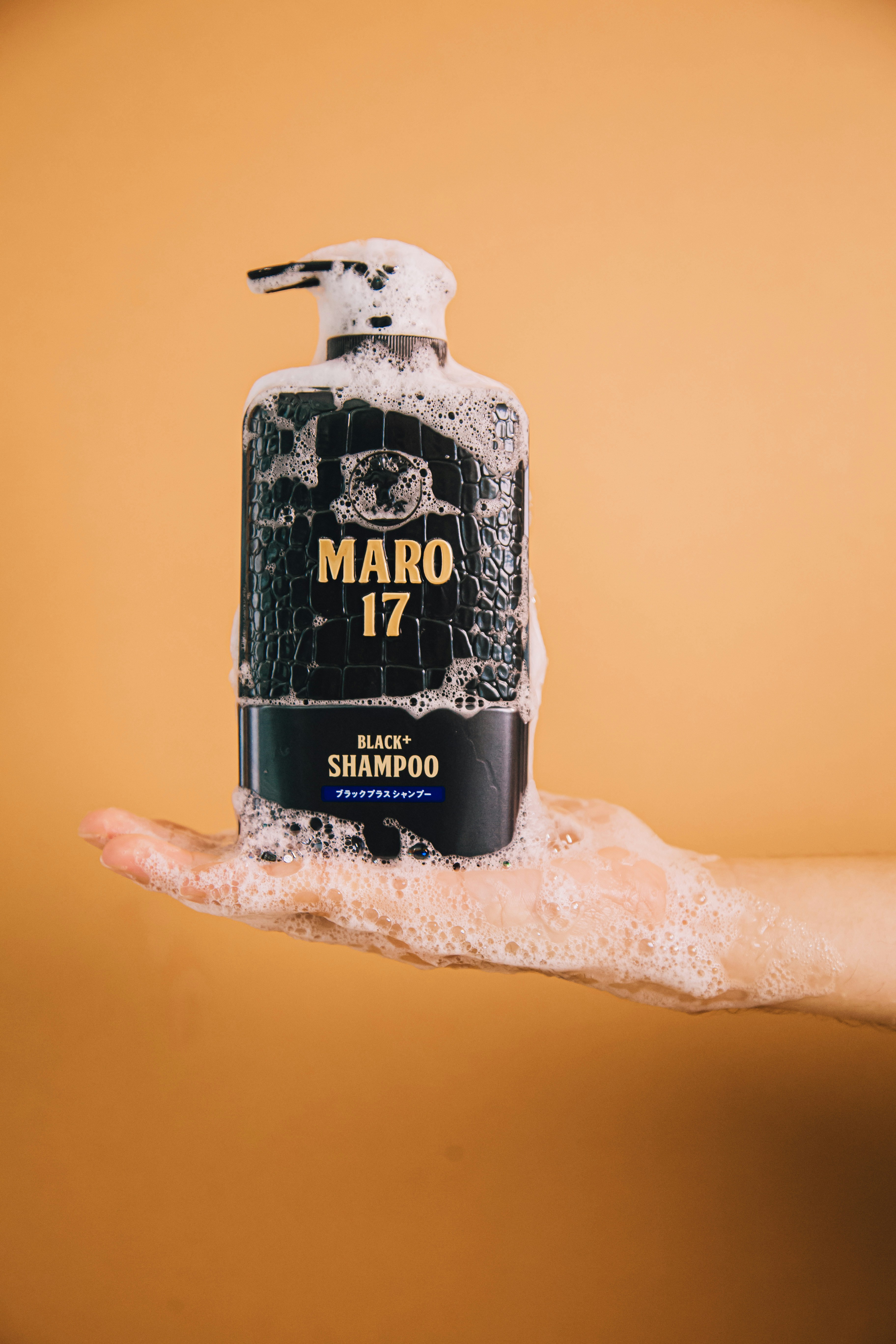 a hand holding a bottle of alcohol