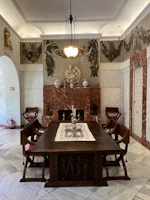 High-end dining room set crafted from solid wood and marble, illuminated by warm ambient lighting