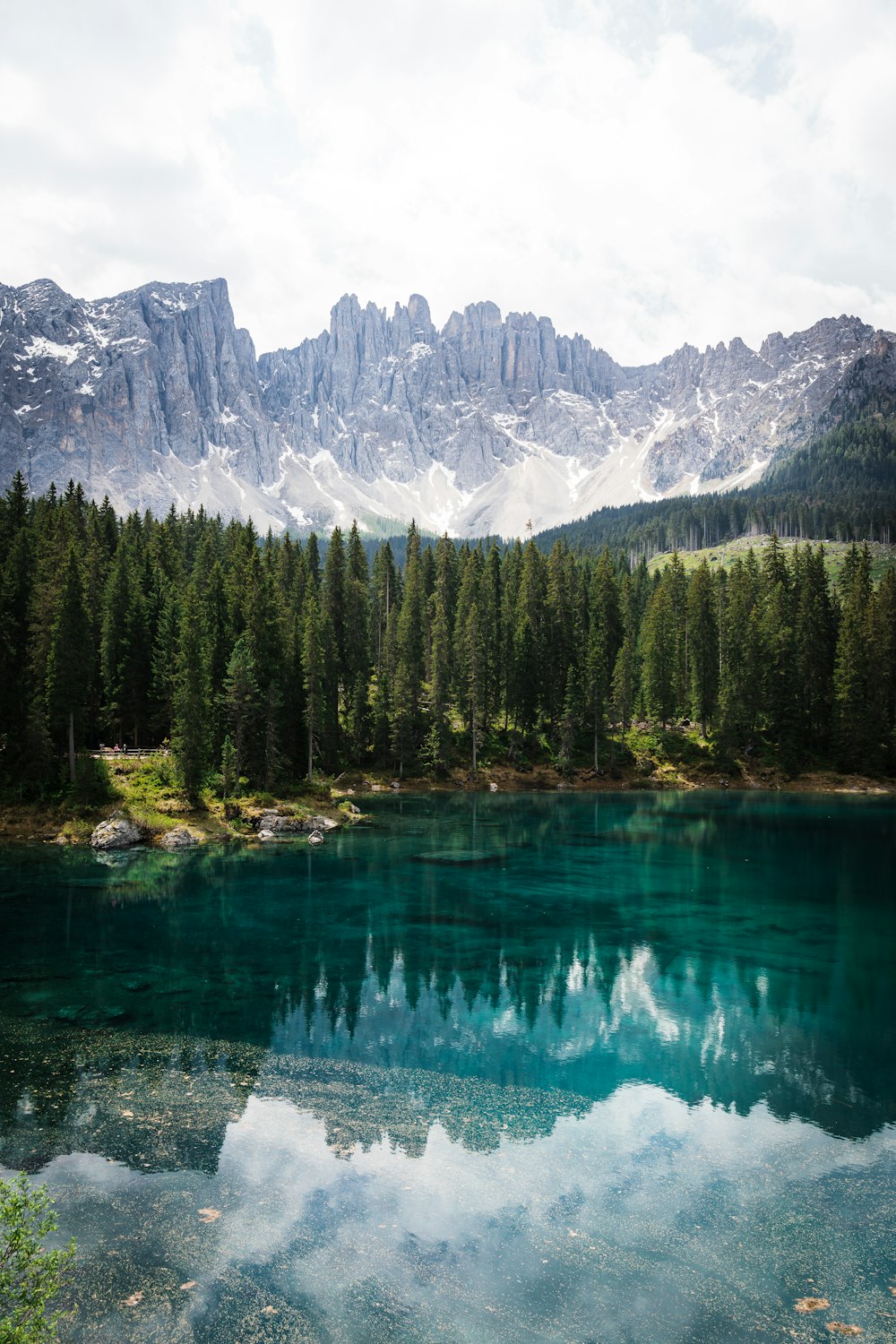 a lake with trees and mountains in the background