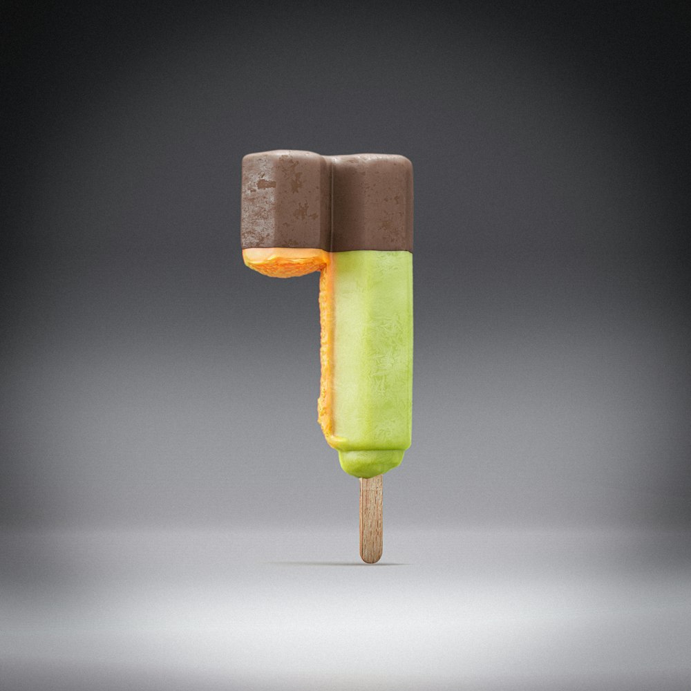 a popsicle with a green top