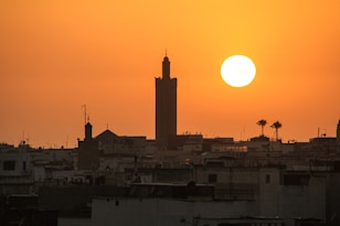 a large building with a tower in the middle of a city