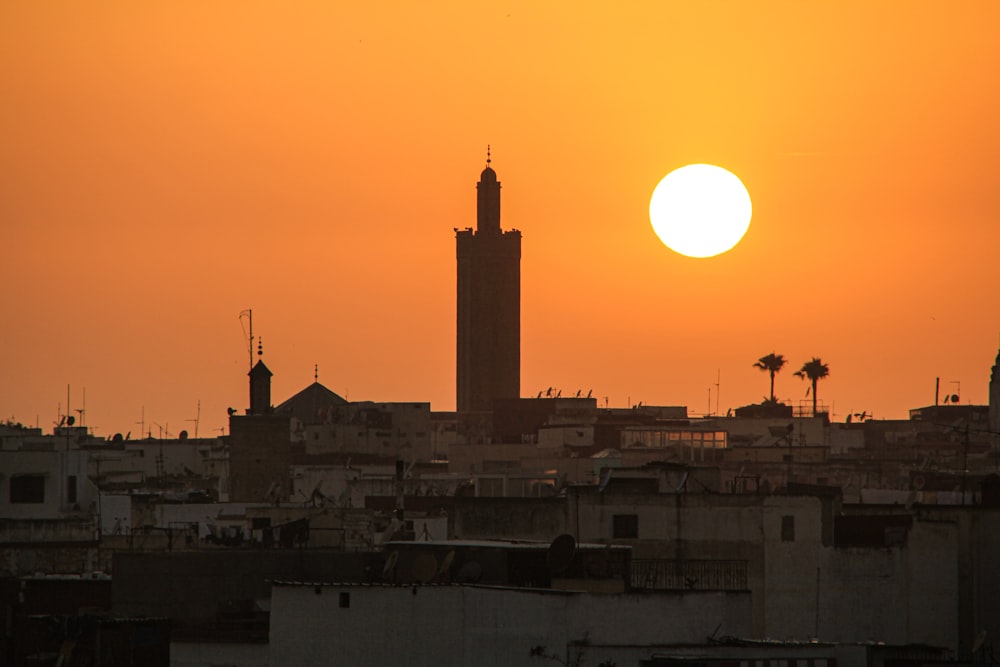 a large building with a tower in the middle of a city