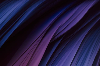 Abstract close-up of rich textures in midnight navy and warm slate, reflecting quiet luxury.