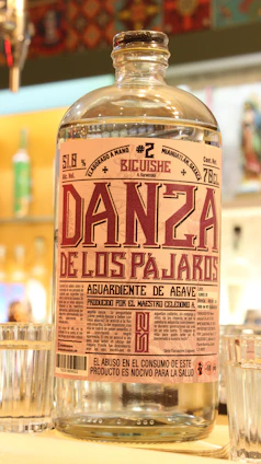 Close-up of a traditional bottle of artisanal pisco with a rustic label from Valle de Ica.