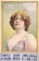 A vintage poster features a woman with curly hair wearing an elaborate headdress adorned with feathers and jewels. She is dressed in an ornate gown with beads and patterns, exuding a sense of glamour and sophistication. The background is a gradient of green, framed with ornate golden borders, and text reading 'LIND' and 'SPECIAL ADDED ATTRACTION' is prominently displayed.