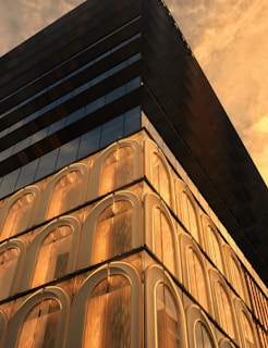 A panoramic view of a completed commercial building with clean lines and golden accents reflecting the brand.