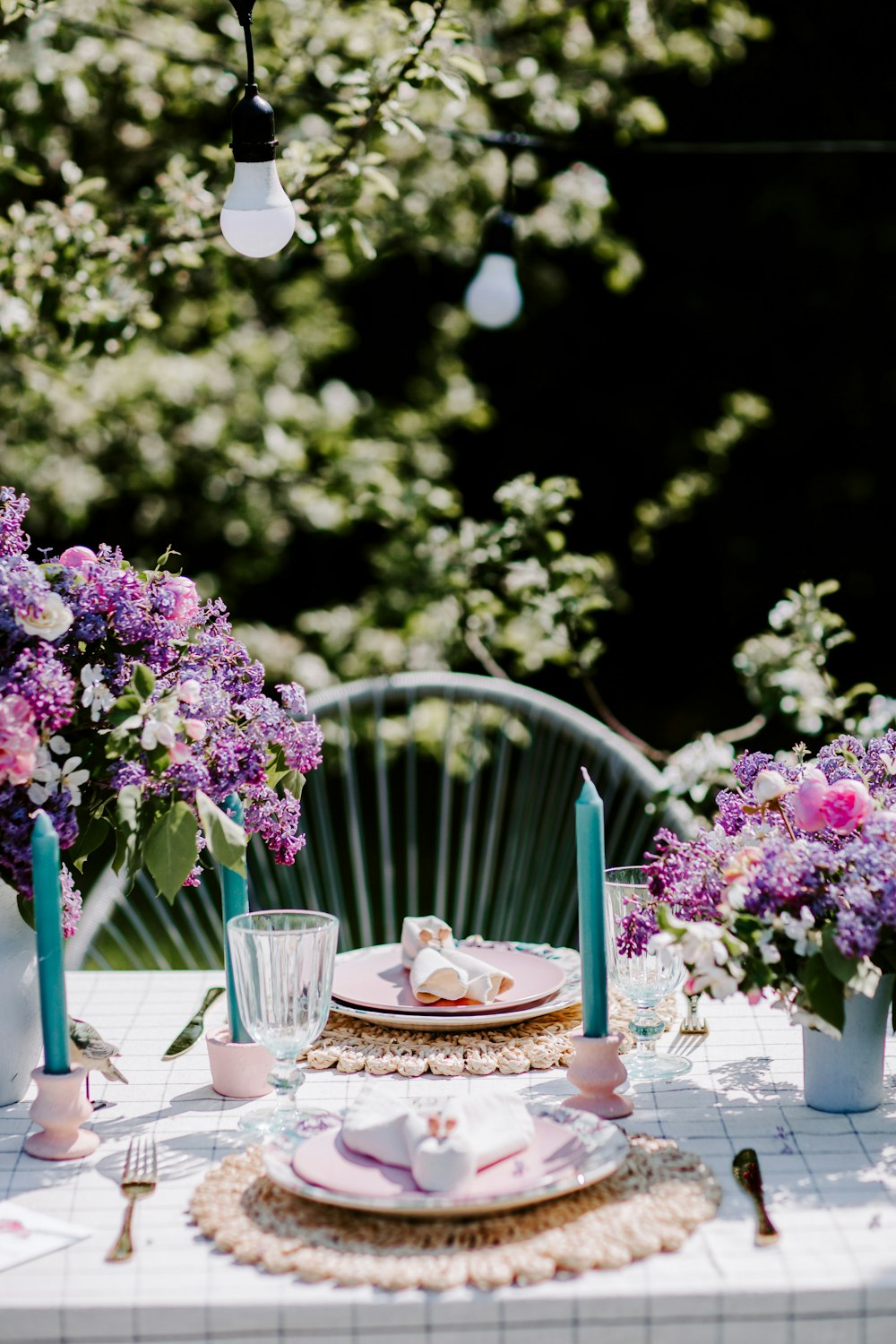 a table with plates and candles on it